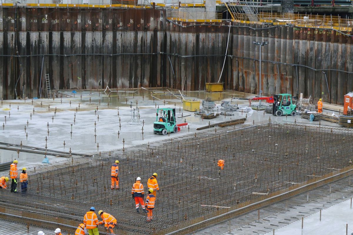 A large construction site with workers on the foundations