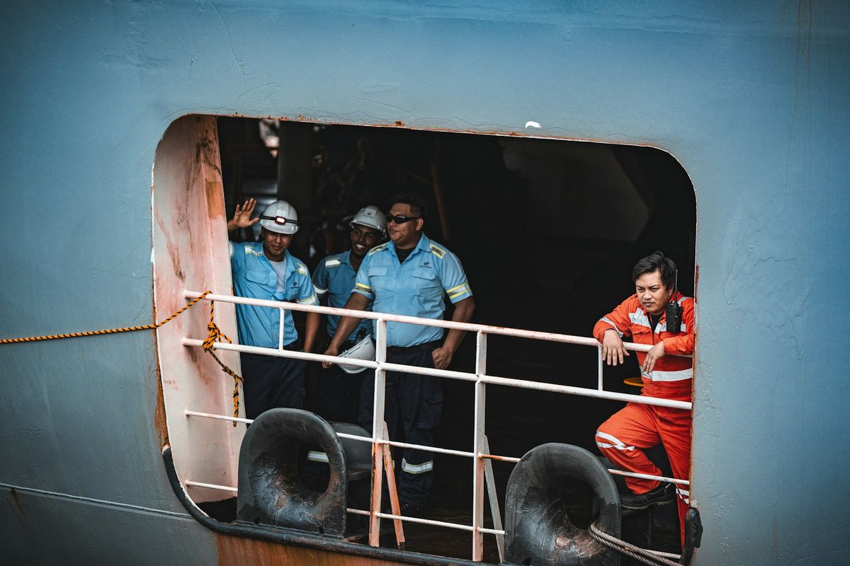 Crew members at a shell door on a ship