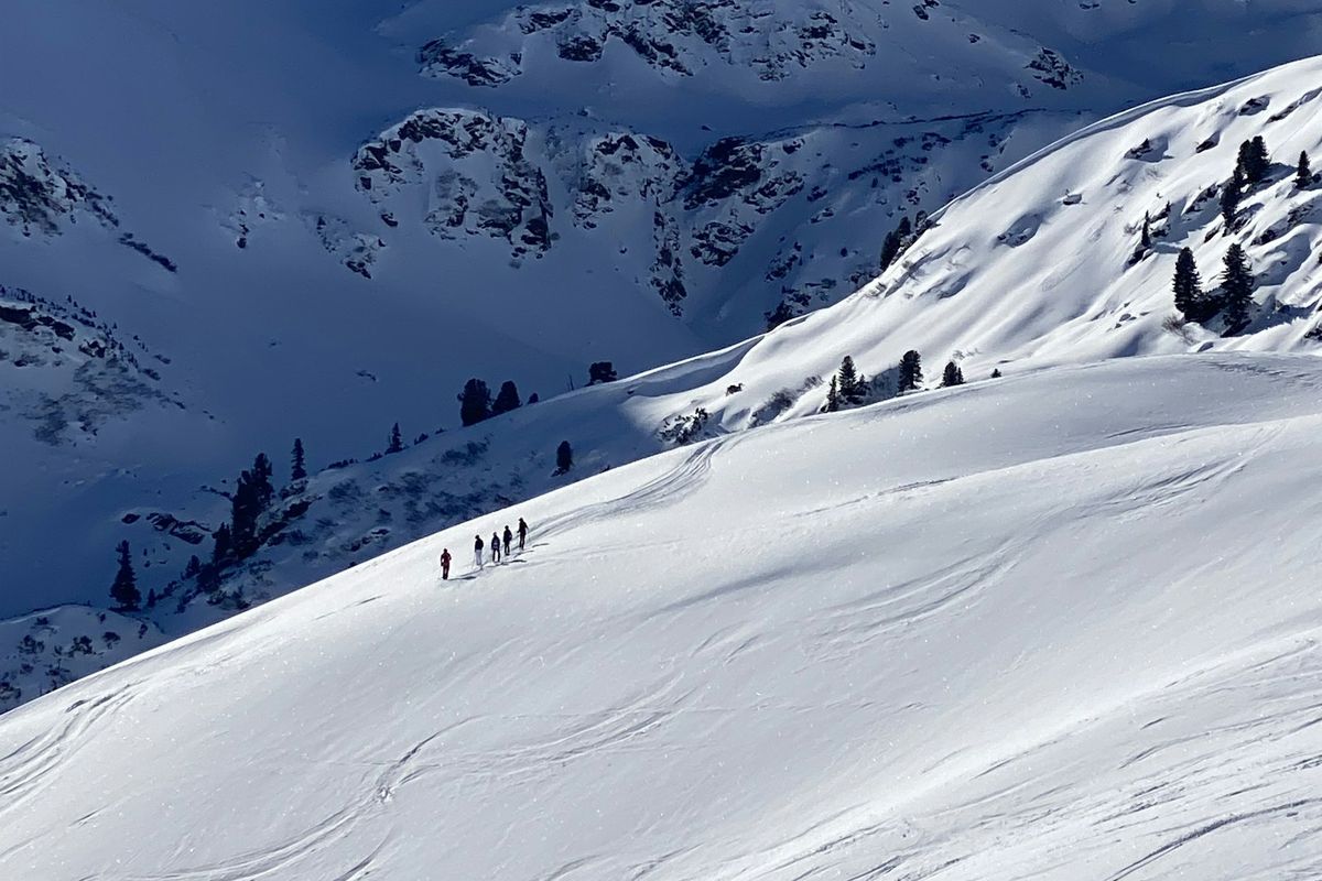 A ski-touring group crossing a snow slope